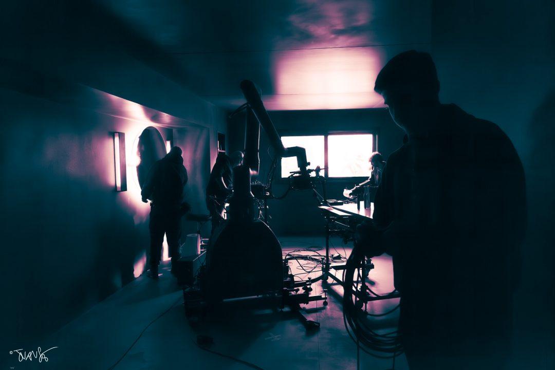 Technicians adjusting the CINEBOT Max in a TV commercial set.